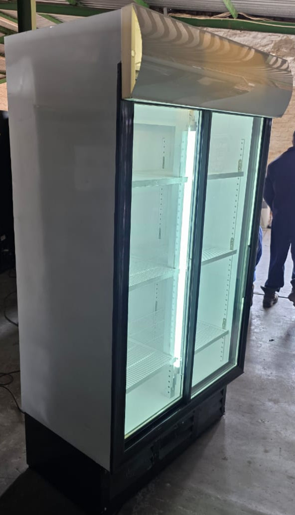 Large glass-fronted refrigerator or freezer in an industrial setting.